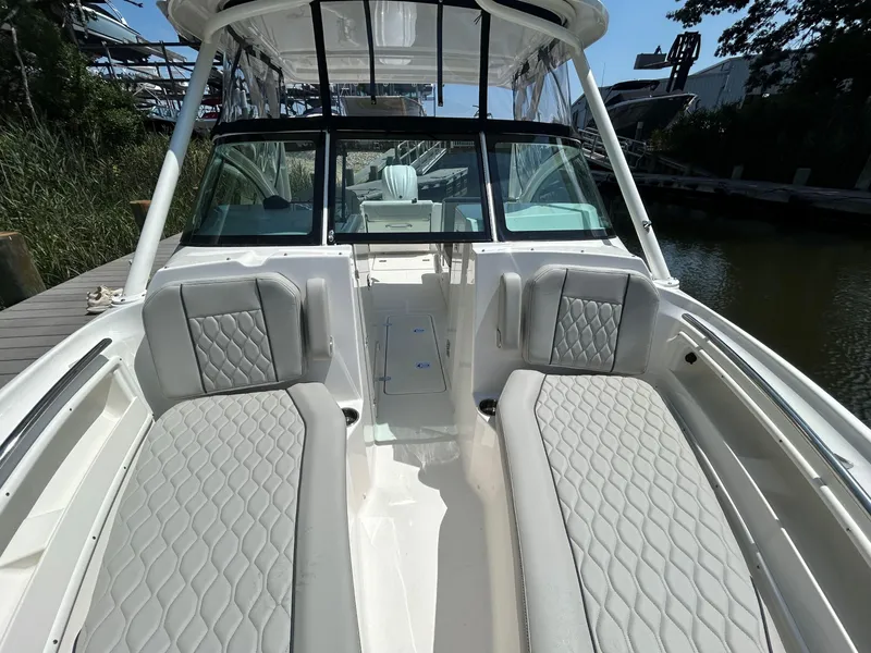 Slide: The Image of 2026 Pursuit DC 246 Dual Console boat interior with gray seating and sleek design. - 23
