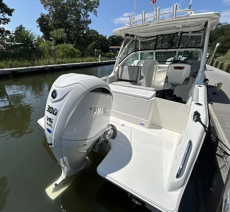 Slide: The Image of 2026 Pursuit DC 246 Dual Console boat with Yamaha 300 V6 engine docked. - 3