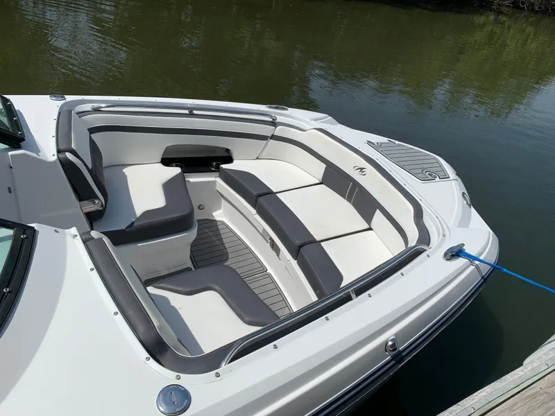 Slide: The Image of 2021 Monterey M6 boat with spacious seating, docked on calm water. - 6