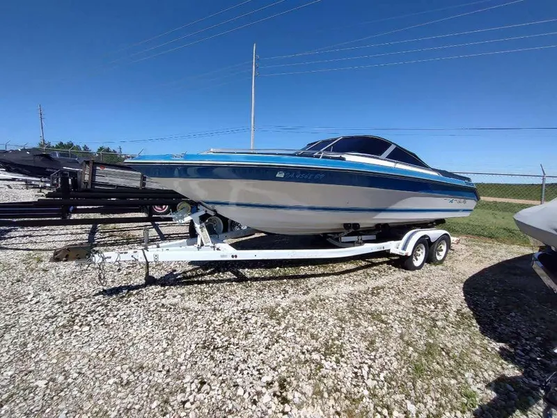 Slide: The Image of 1988 Sea Ray 230 Bow Rider Select on trailer, parked on gravel lot. - 12
