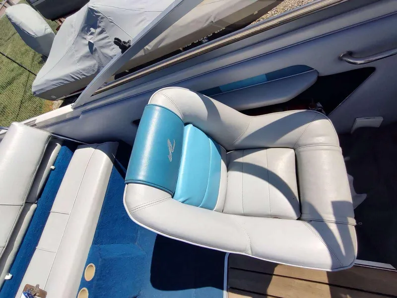 Slide: The Image of 1988 Sea Ray 230 Bow Rider Select boat interior with blue and white seating. - 15
