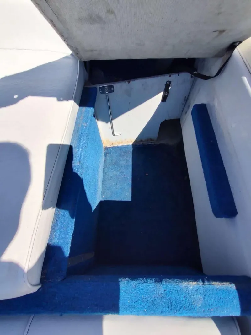 Slide: The Image of Interior of 1988 Sea Ray 230 Bow Rider Select with blue carpet and white seating. - 17