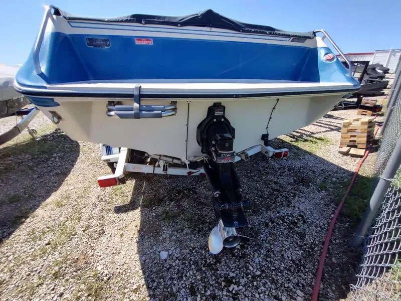 Slide: The Image of 1988 Sea Ray 230 Bow Rider Select boat, rear view, on gravel surface. - 18