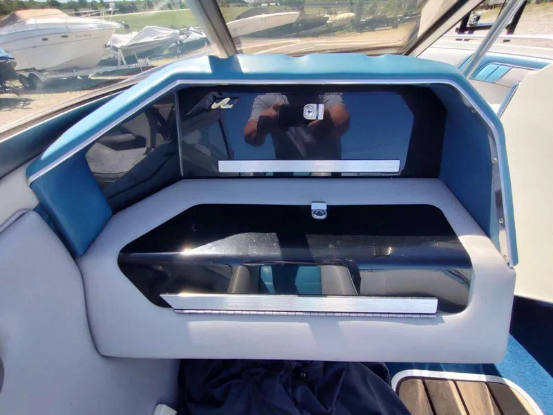 Slide: The Image of 1988 Sea Ray 230 Bow Rider Select interior dashboard with blue and black accents. - 4