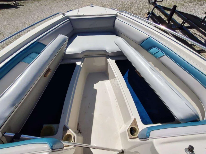 Slide: The Image of 1988 Sea Ray 230 Bow Rider Select interior with blue and white seating. - 5