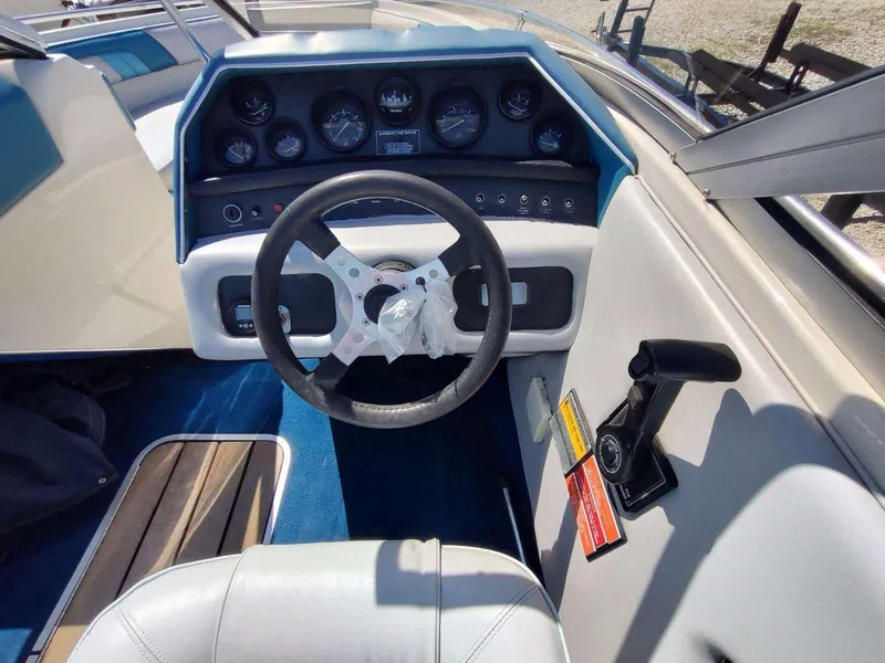 Slide: The Image of 1988 Sea Ray 230 Bow Rider Select dashboard with steering wheel and instrument panel. - 6