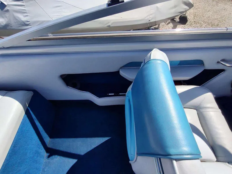 Slide: The Image of 1988 Sea Ray 230 Bow Rider Select interior with blue and white seating. - 9