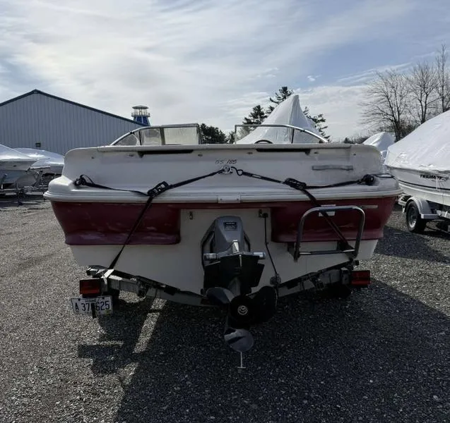 Slide: The Image of 1999 Glastron 185 boat, rear view, parked outdoors on gravel. - 7