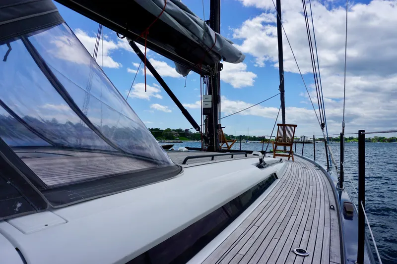 Slide: The Image of 2020 Beneteau First 53 sailboat deck with clear skies and calm waters. - 23