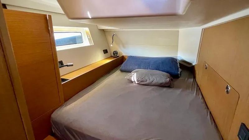 Slide: The Image of Cozy cabin interior of 2020 Beneteau First 53 yacht with bed and wooden furnishings. - 43