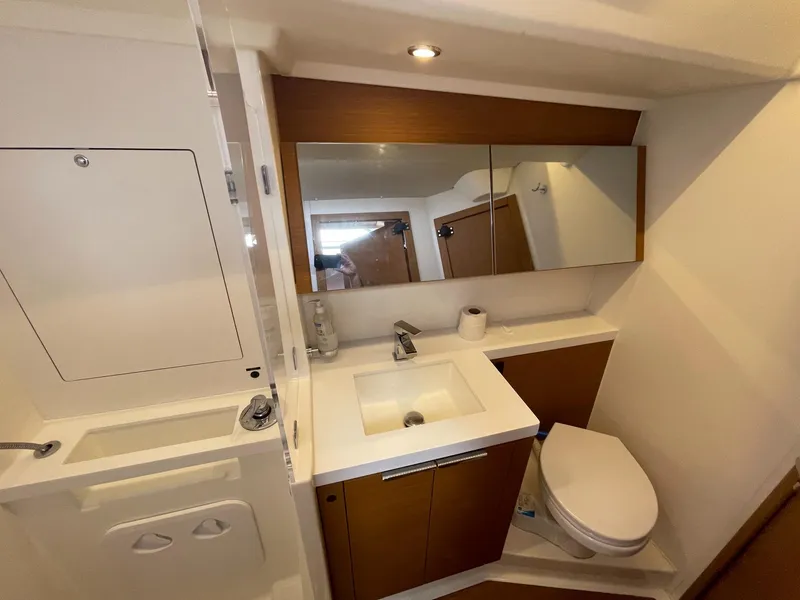 Slide: The Image of Modern bathroom in 2020 Beneteau First 53 yacht with sink, mirror, and toilet. - 46
