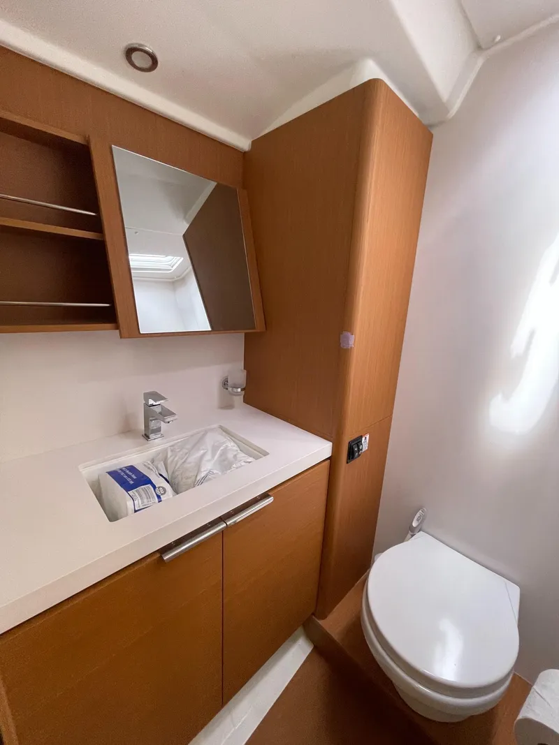 Slide: The Image of 2020 Beneteau First 53 yacht bathroom with modern fixtures and wooden cabinetry. - 47