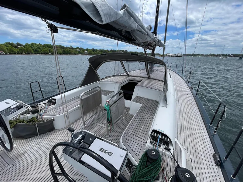 Slide: The Image of Sleek 2020 Beneteau First 53 yacht on calm waters, showcasing spacious deck and modern design. - 8