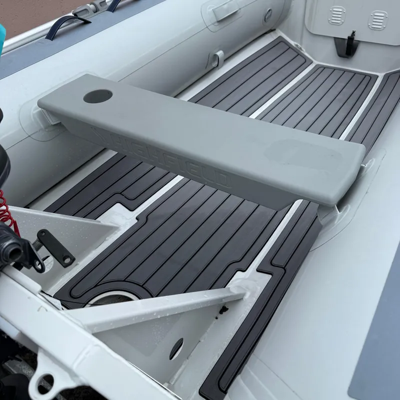 Slide: The Image of 2024 Highfield CL340 inflatable boat interior with gray seating and non-slip flooring. - 11