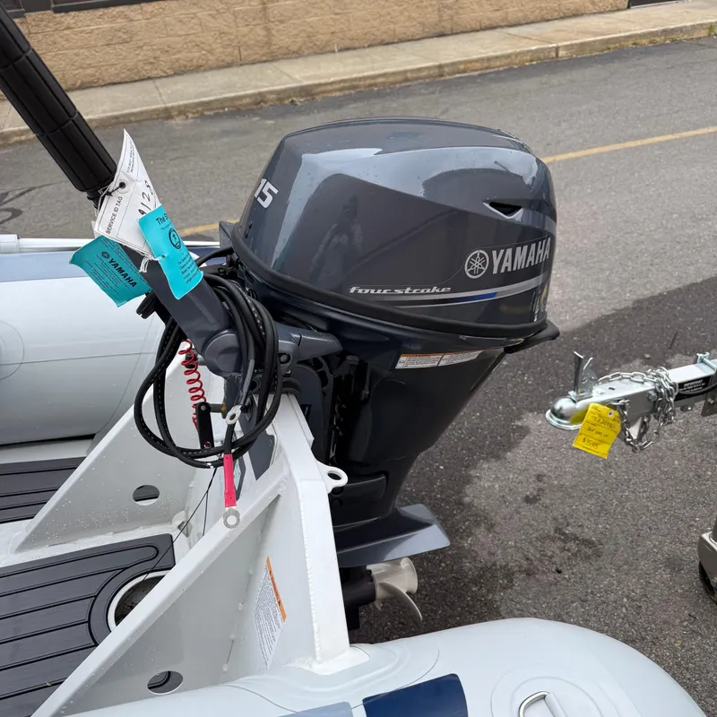 Slide: The Image of 2024 Highfield CL340 boat with Yamaha outboard motor, parked on a street. - 5