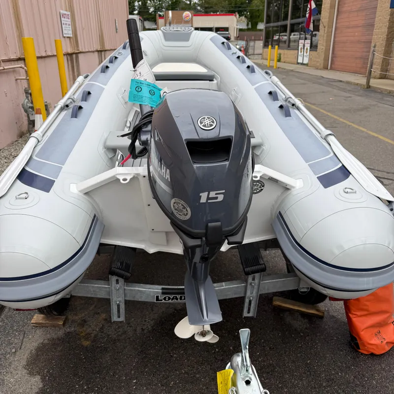 Slide: The Image of 2024 Highfield CL340 inflatable boat with Yamaha 15HP outboard motor on a trailer. - 7