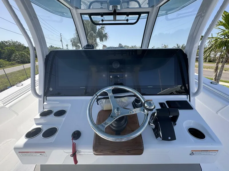 Slide: The Image of Helm of 2025 Sportsman 352 Open boat with modern controls and steering wheel. - 19