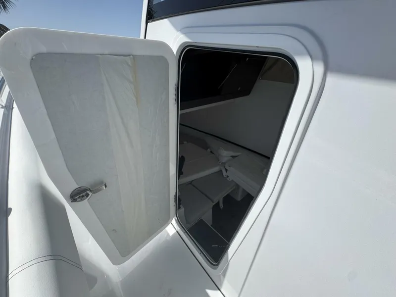 Slide: The Image of Open hatch on 2025 Sportsman 352 Open boat, revealing interior storage space. - 22