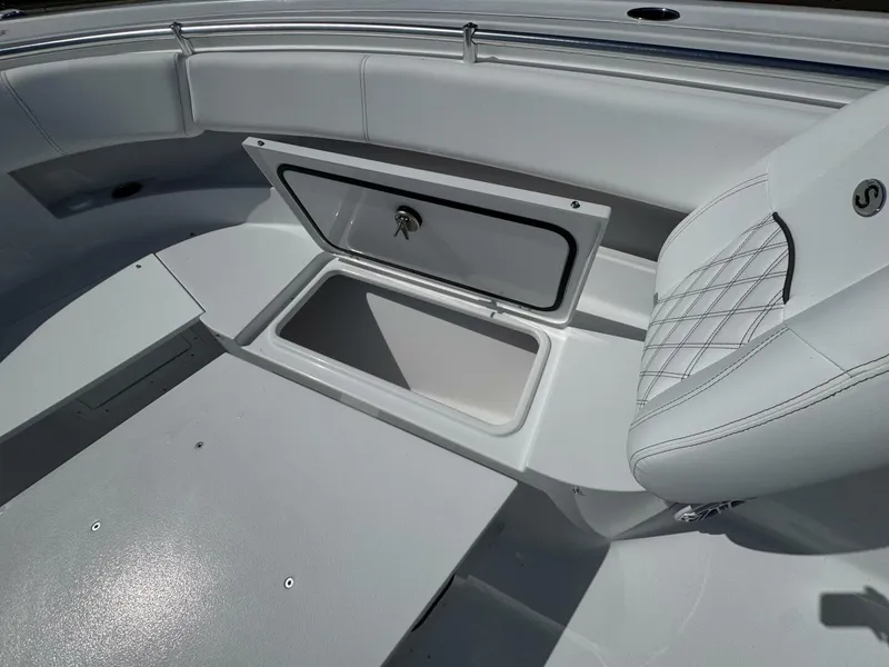 Slide: The Image of 2025 Sportsman 352 Open boat interior with open storage compartment and cushioned seating. - 24