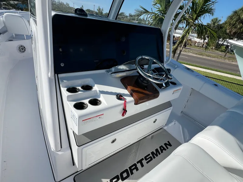 Slide: The Image of 2025 Sportsman 352 Open boat console with steering wheel and cup holders. - 30