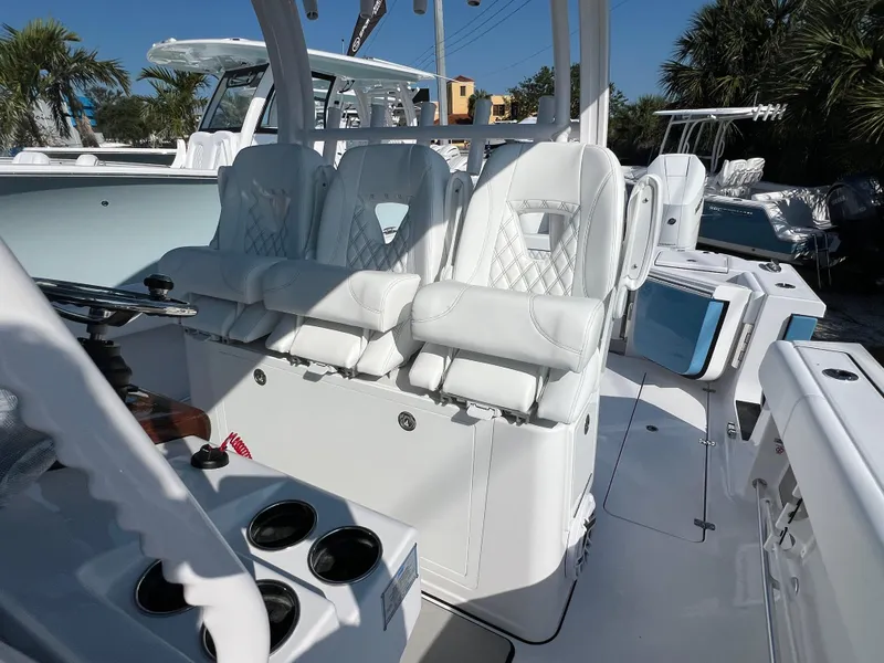 Slide: The Image of 2025 Sportsman 352 Open boat interior with white cushioned seating and cup holders. - 35