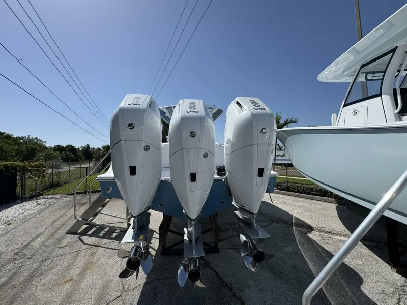 Slide: The Image of 2025 Sportsman 352 Open boat with triple outboard engines in a sunny outdoor setting. - 4