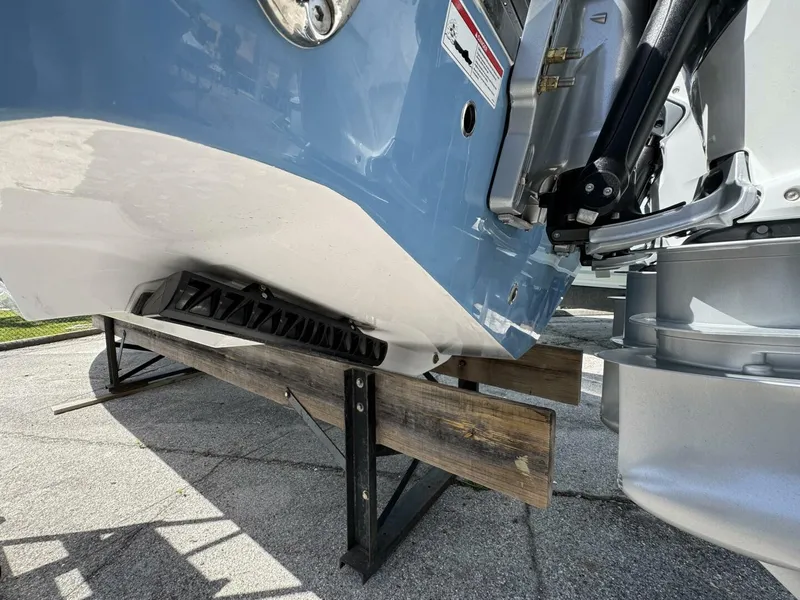 Slide: The Image of 2025 Sportsman 352 Open boat hull and engine detail on wooden support. - 5