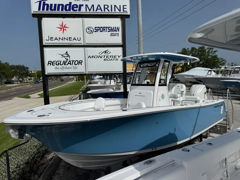 Slide: The Image of 2025 Sportsman 232 Open boat displayed at Thunder Marine dealership. - 0
