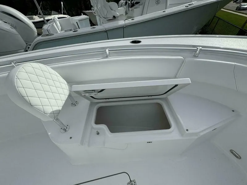 Slide: The Image of 2025 Sportsman 232 Open boat interior with open storage compartment and cushioned seat. - 11