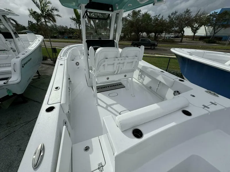 Slide: The Image of 2025 Sportsman 232 Open boat interior with seating and console, parked outdoors. - 2