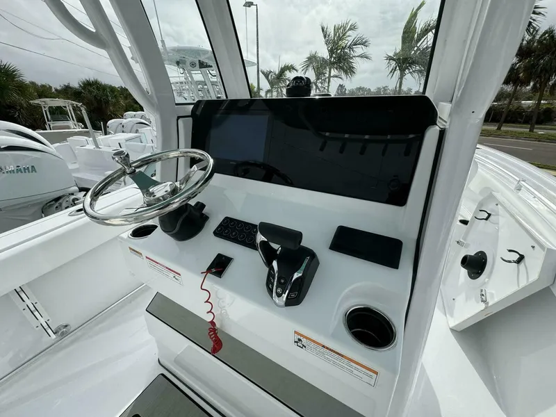 Slide: The Image of 2025 Sportsman 232 Open boat console with steering wheel and controls. - 6