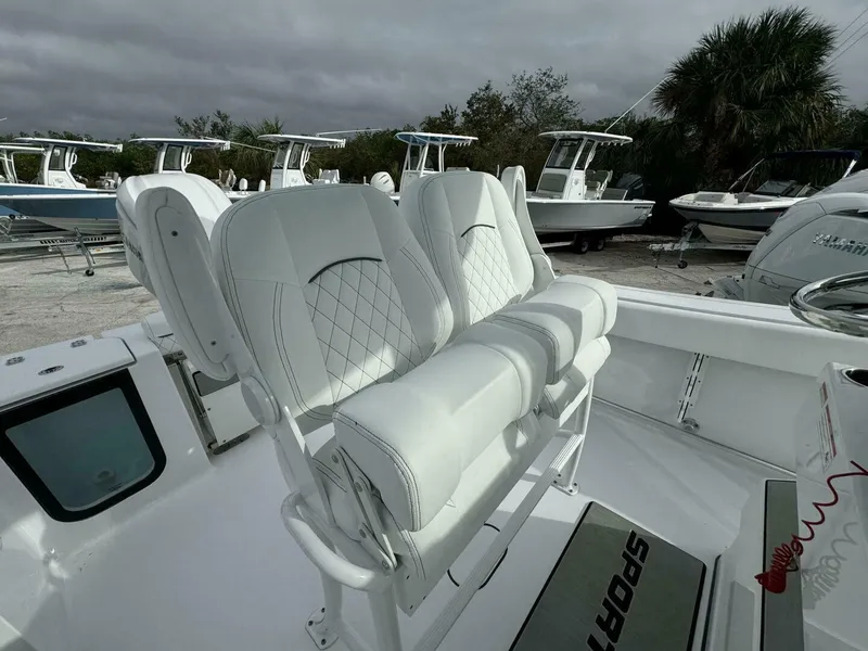 Slide: The Image of 2025 Sportsman 232 Open boat with white cushioned seating and sleek design. - 7