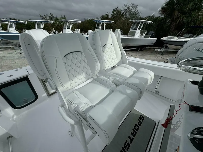 Slide: The Image of 2025 Sportsman 232 Open boat with white cushioned seating and sleek design. - 8