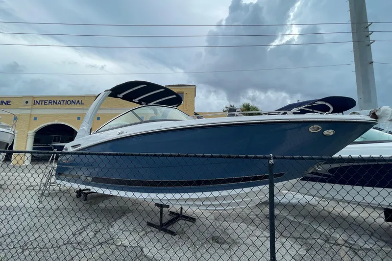 The Image of 2025 Monterey M-255 boat displayed at a dealership, under a cloudy sky. - 0