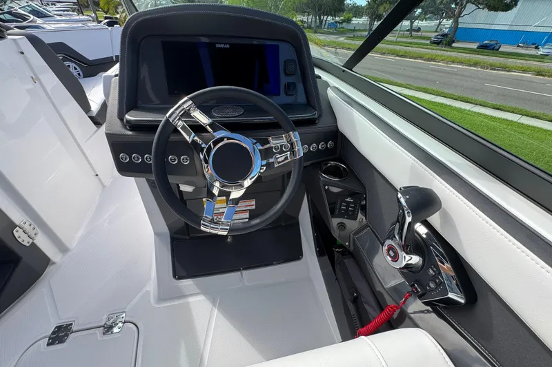 Slide: The Image of Cockpit of 2025 Monterey M-255 boat with modern steering and control panel. - 15