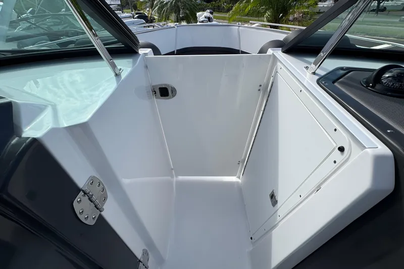 Slide: The Image of 2025 Monterey M-255 boat interior storage compartment with sleek design and modern features. - 16