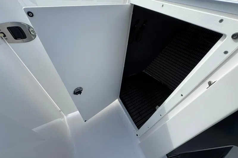 Slide: The Image of Open storage compartment on 2025 Monterey M-255 boat, featuring sleek white design. - 17