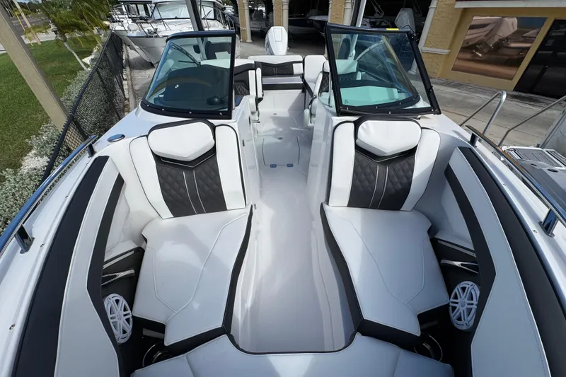 Slide: The Image of 2025 Monterey M-255 boat interior with sleek white and black seating, open windshield, and modern design. - 19
