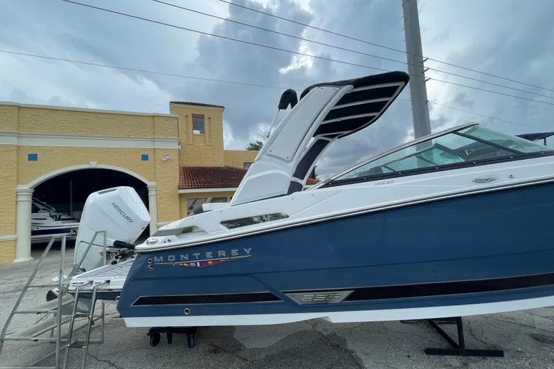 Slide: The Image of 2025 Monterey M-255 boat with Mercury engine, displayed outdoors under cloudy skies. - 3