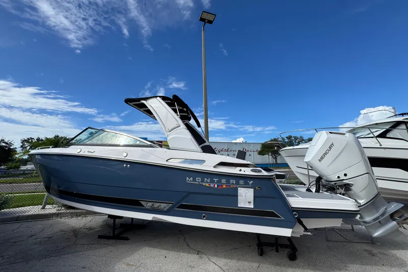 Slide: The Image of 2025 Monterey M-255 boat with Mercury engine, displayed outdoors under a clear blue sky. - 4