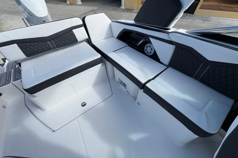 Slide: The Image of 2025 Monterey M-255 boat interior with white and black cushioned seating. - 9