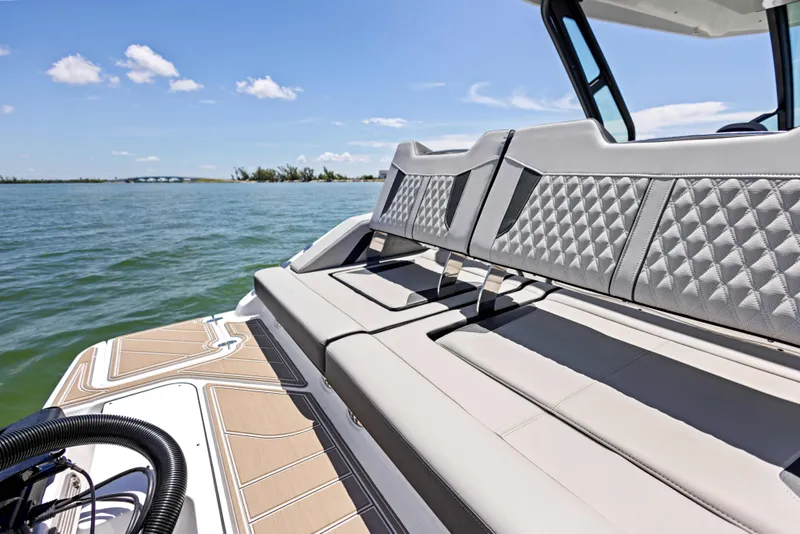 Slide: The Image of 2026 Monterey Elite 30 OB boat with luxurious seating on a sunny day. - 15