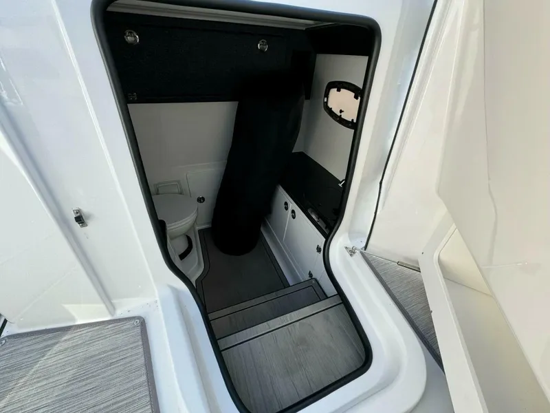 Slide: The Image of Interior cabin of 2025 Monterey 30 ELITE boat with toilet and storage. - 7