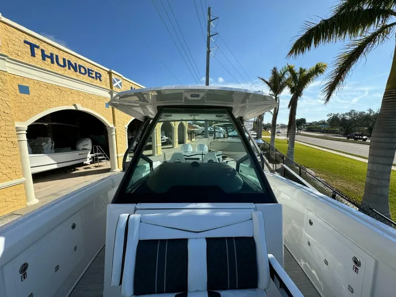 Slide: The Image of 2025 Monterey 30 ELITE boat at Thunder dealership, sunny day, palm trees in background. - 9