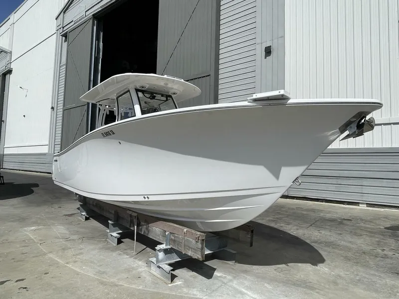 Slide: The Image of 2021 Sportsman 302 OPEN boat in a storage facility, side view. - 1