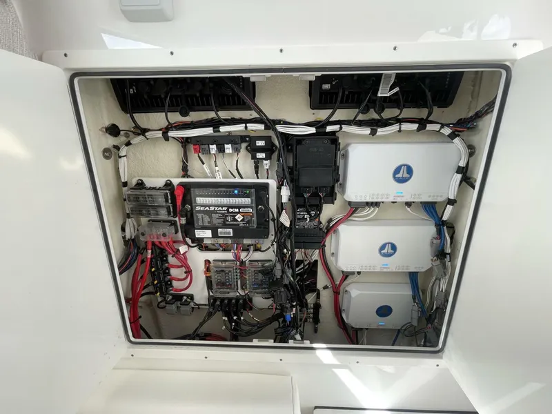 Slide: The Image of Electrical panel of a 2021 Sportsman 302 OPEN boat, showcasing wiring and components. - 14