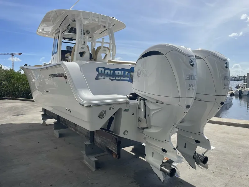 Slide: The Image of 2021 Sportsman 302 OPEN boat with twin Yamaha 300 engines on a sunny dock. - 3
