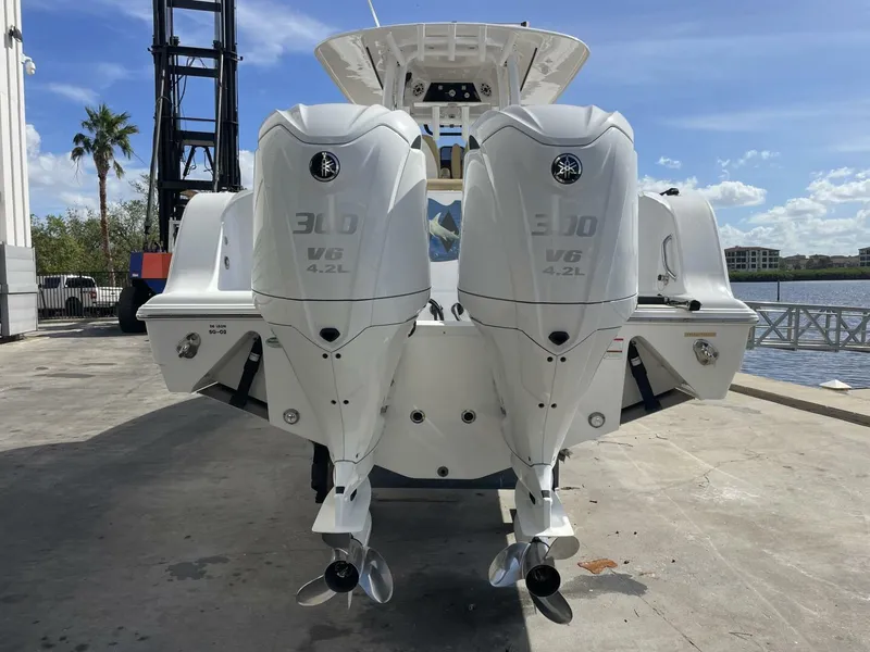 Slide: The Image of 2021 Sportsman 302 OPEN boat with twin 300 V6 4.2L engines at dockside. - 4