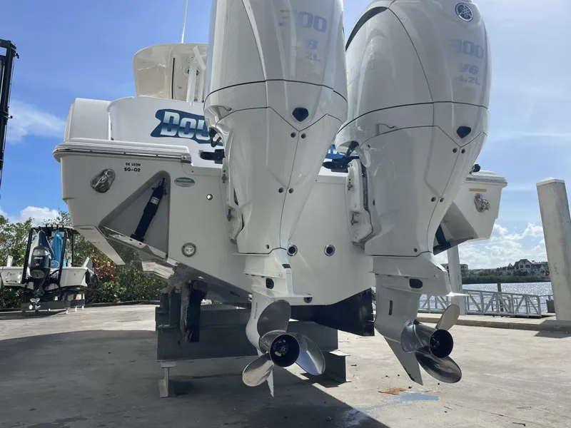 Slide: The Image of 2021 Sportsman 302 OPEN boat with dual outboard engines on a sunny dock. - 5