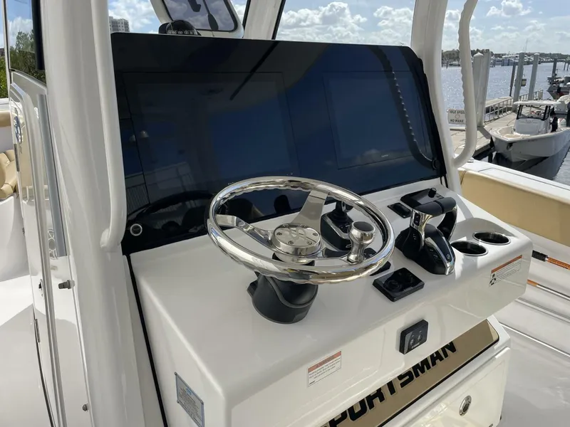 Slide: The Image of Steering console of a 2021 Sportsman 302 OPEN boat, featuring modern controls and a sleek design. - 7